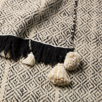 Margosa Primani Throw by Jaipur Living in gray, cream. Made from 100% wool in a cottage & farmhouse style.
