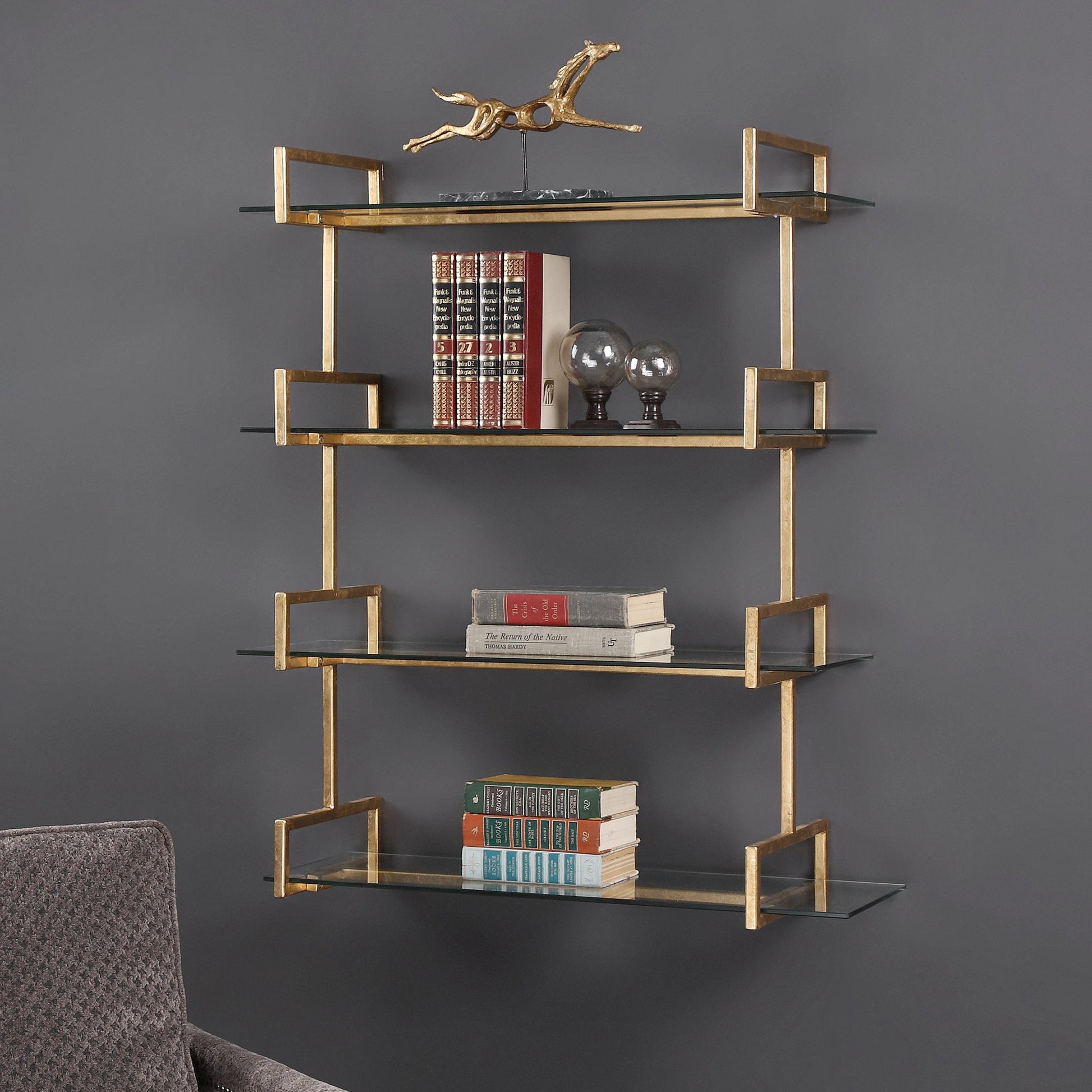 Auley Wall Shelf by Uttermost in gold. Made from iron, tempered glass in a modern style.