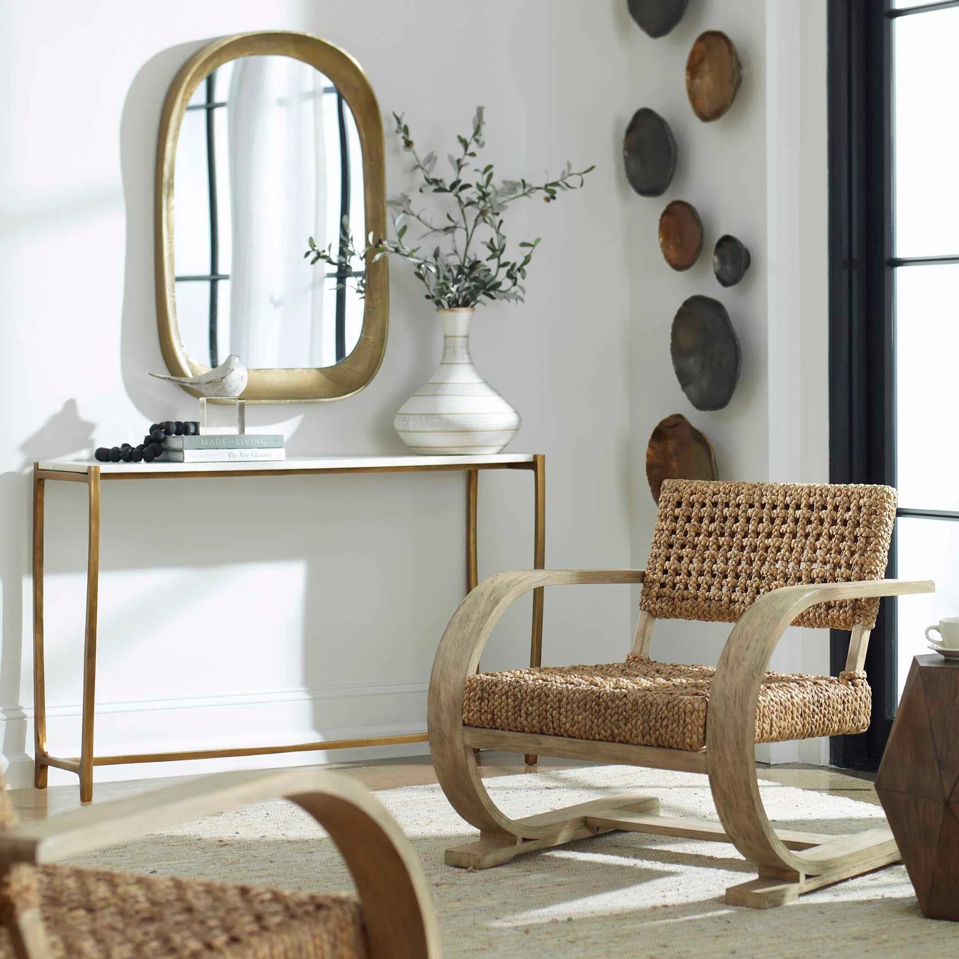 Bradano Arch Mirror by Uttermost in brass. Made from cast aluminum, glass, mdf in a modern style.