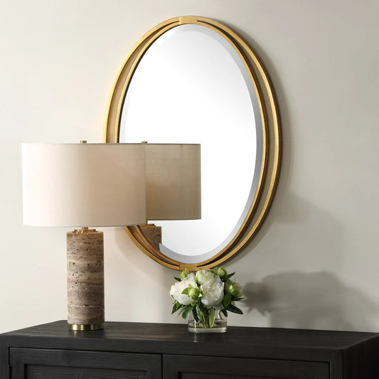 Rhodes Oval Mirror by Uttermost in gold leaf. Made from iron, mdf, mirror in a transitional style.