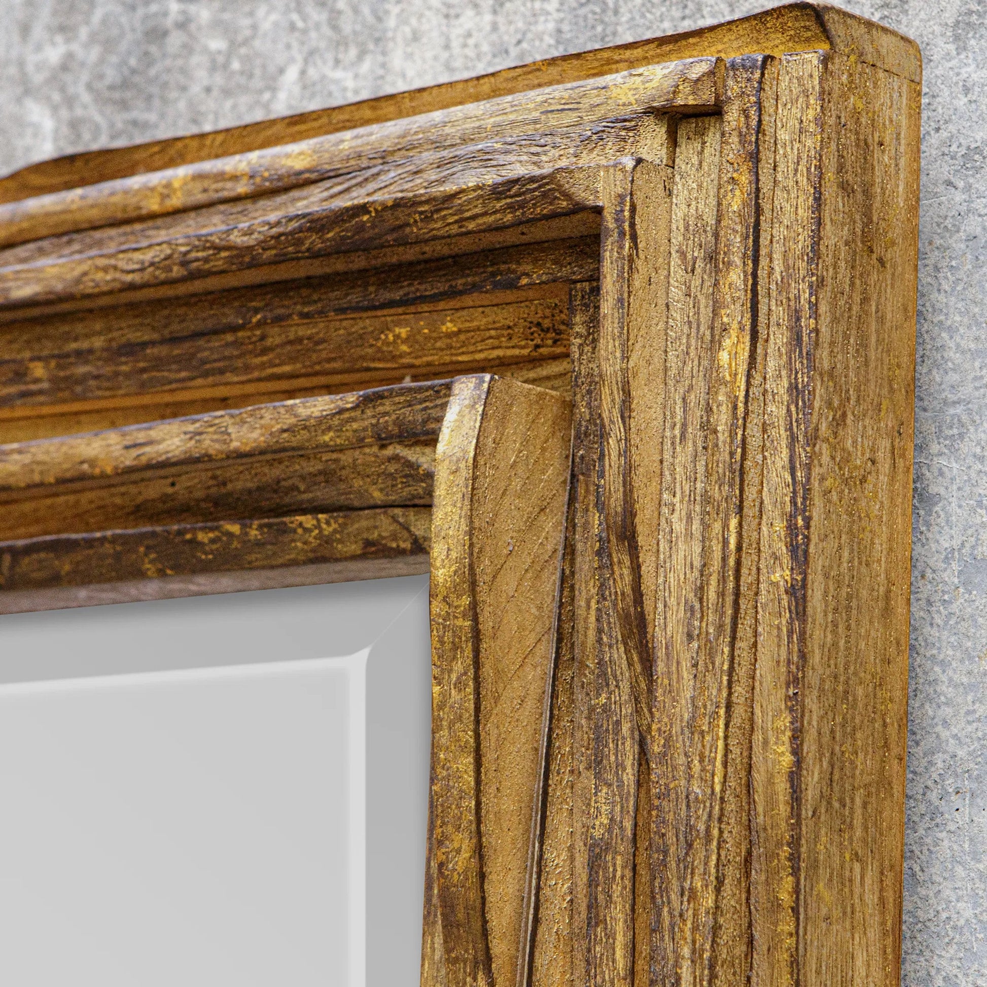 Overlap Mirror by Uttermost in antique gold leaf. Made from teak wood in a transitional style.