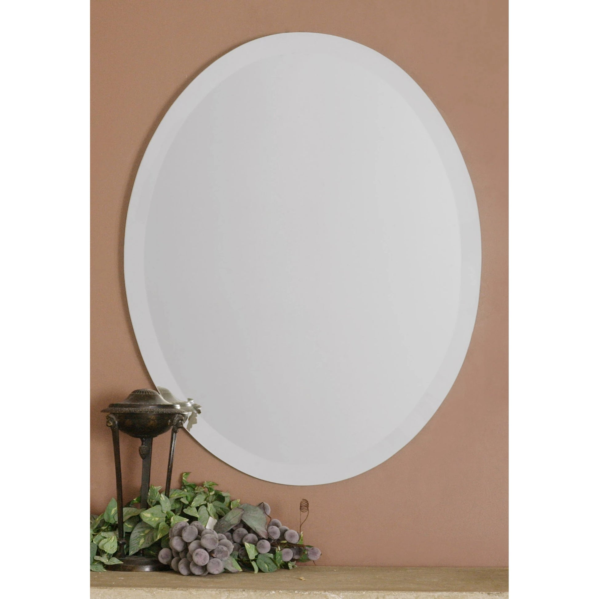 Frameless Vanity Oval Mirror by Uttermost. Made from glass in a modern style.