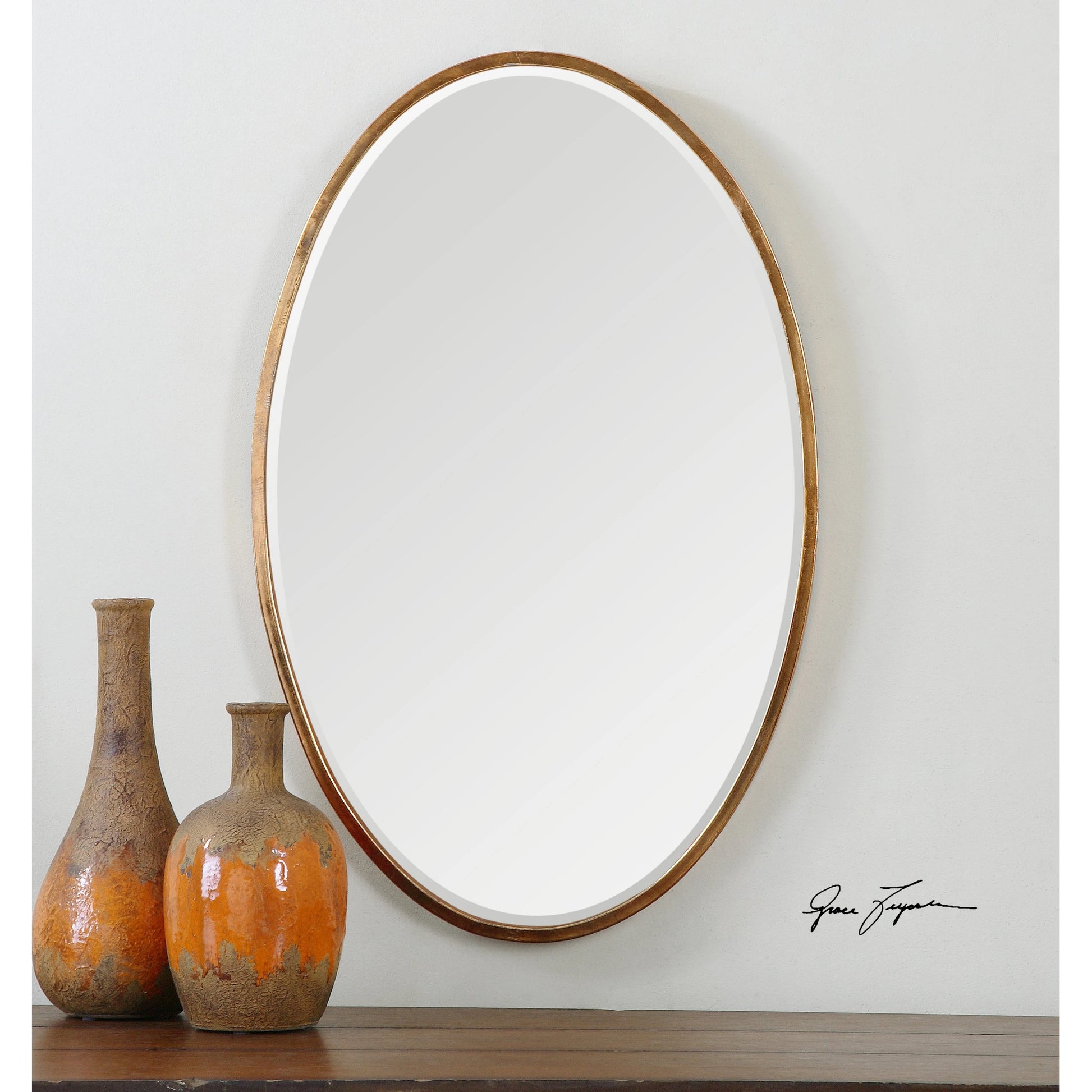 Herleva Mirror by Uttermost in gold. Made from metal in a modern style.