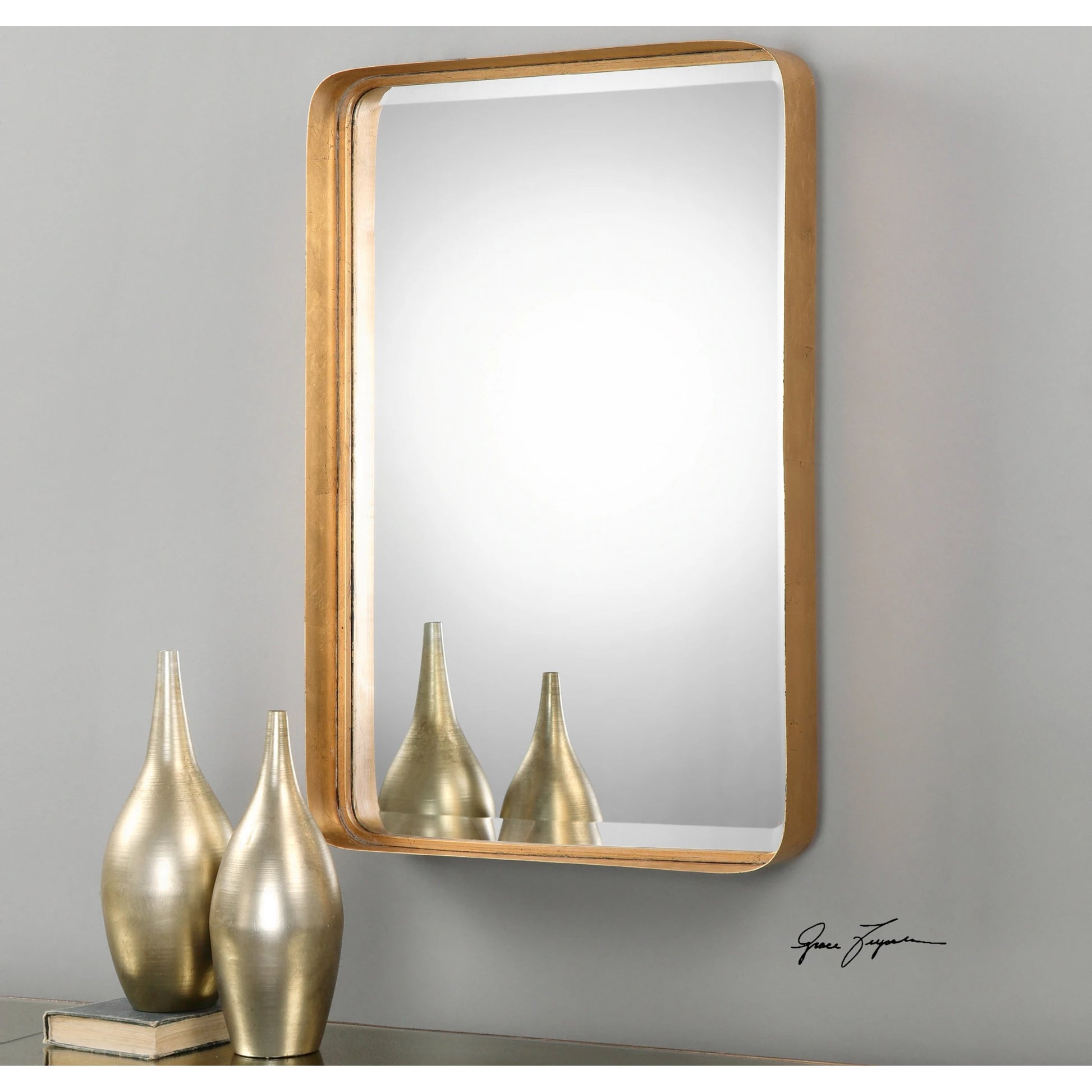 Crofton Vanity Mirror by Uttermost in gold. Made from metal in a modern style.