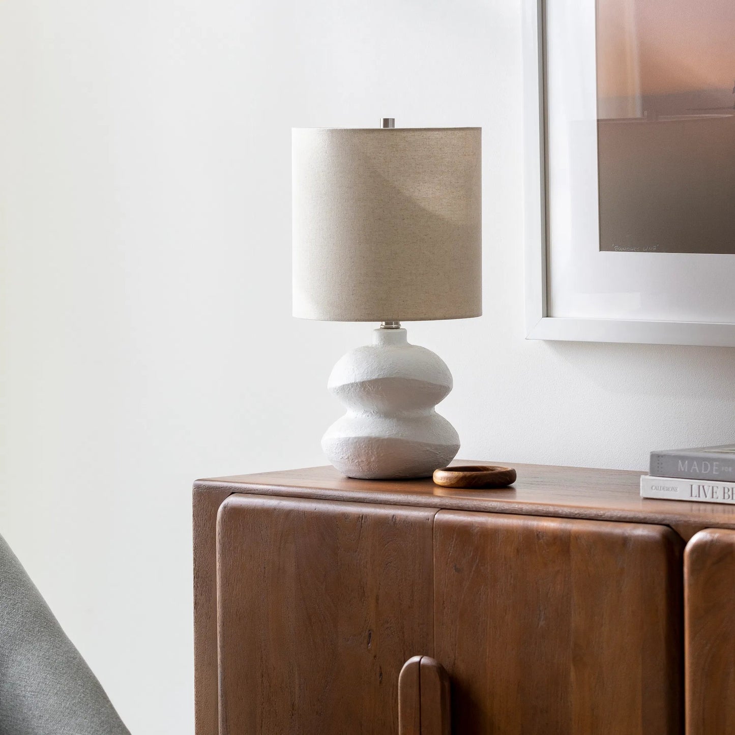 002 SI-2054008 | Lifestyle | Mauna - 500112 by Livabliss in body: white, shade: wheat, finial: metallic - brass, harp: metallic - brass, cord: translucent and colored, polished. Made from body: ceramic, shade (outside): linen, shade (inside): polyester, fi