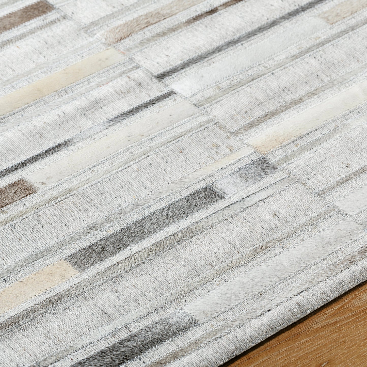 006 SI-2052144,SI-2052145,SI-2052146,SI-2052147 | Closeup | Medora Rug - 489431 by Surya in taupe, ivory, stone grey, charcoal. Made from face: 60% leather, 40% viscose in a unique style.