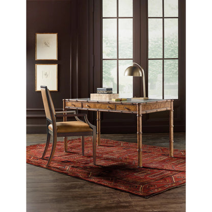 Archives Writing Desk by Hooker Furniture in medium wood and mottled amber. Made from birch veneers, oak veneers, cane, ultra-white tempered glass in a traditional style.