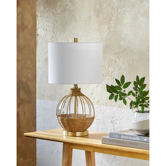 Nelliston - 492811 by Surya in body: clear, base: gold, shade: white, finial: metallic - gold, harp: metallic - gold, cord: translucent and natural. Made from body: glass, base: glass, shade (outside): linen, shade (inside): li