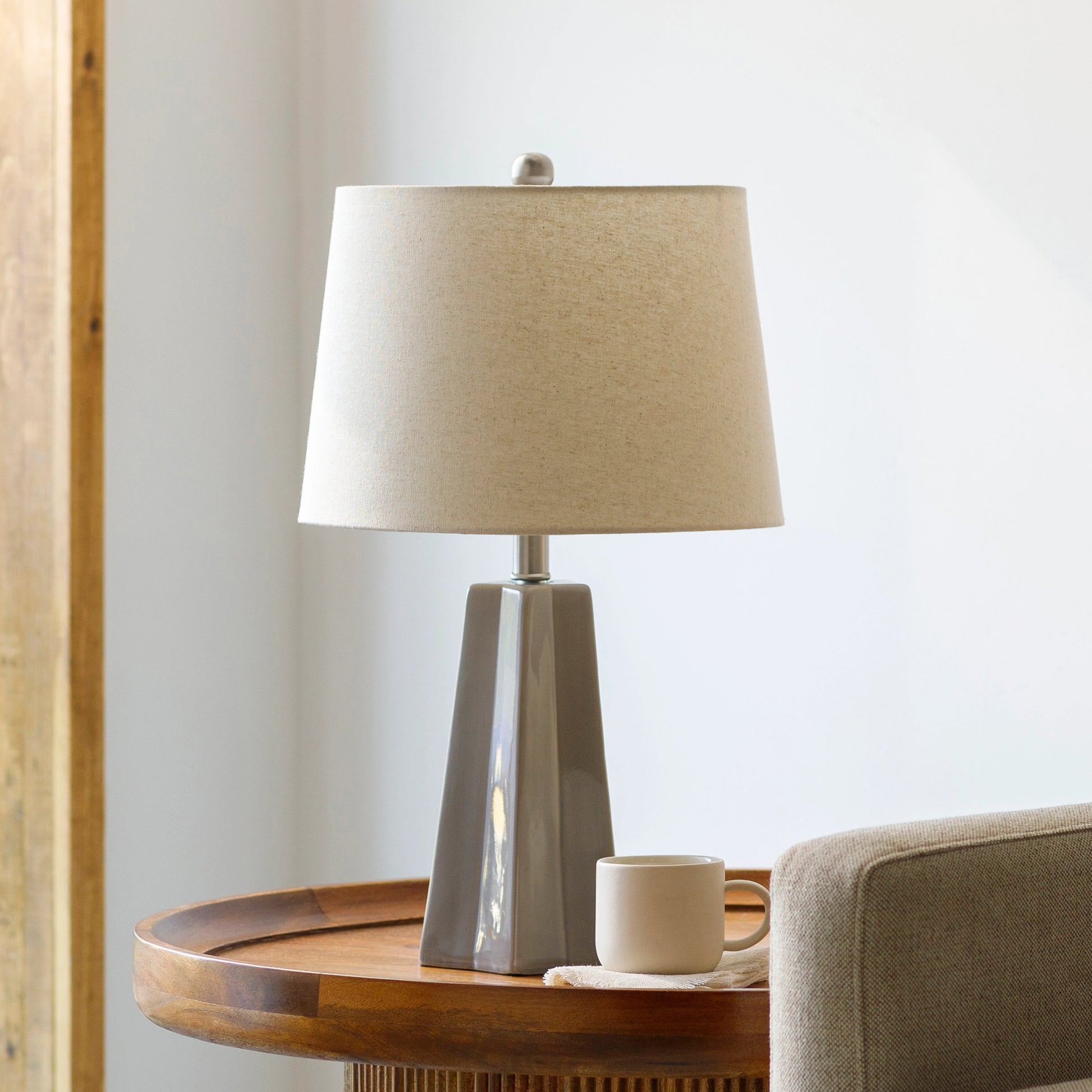 Stellan Table Lamp - 31886 by Livabliss in glazedpolished. Made from shade (outside): linen, shade (inside): polyester, body: ceramic, finial: metal, harp: metal in a modern style.