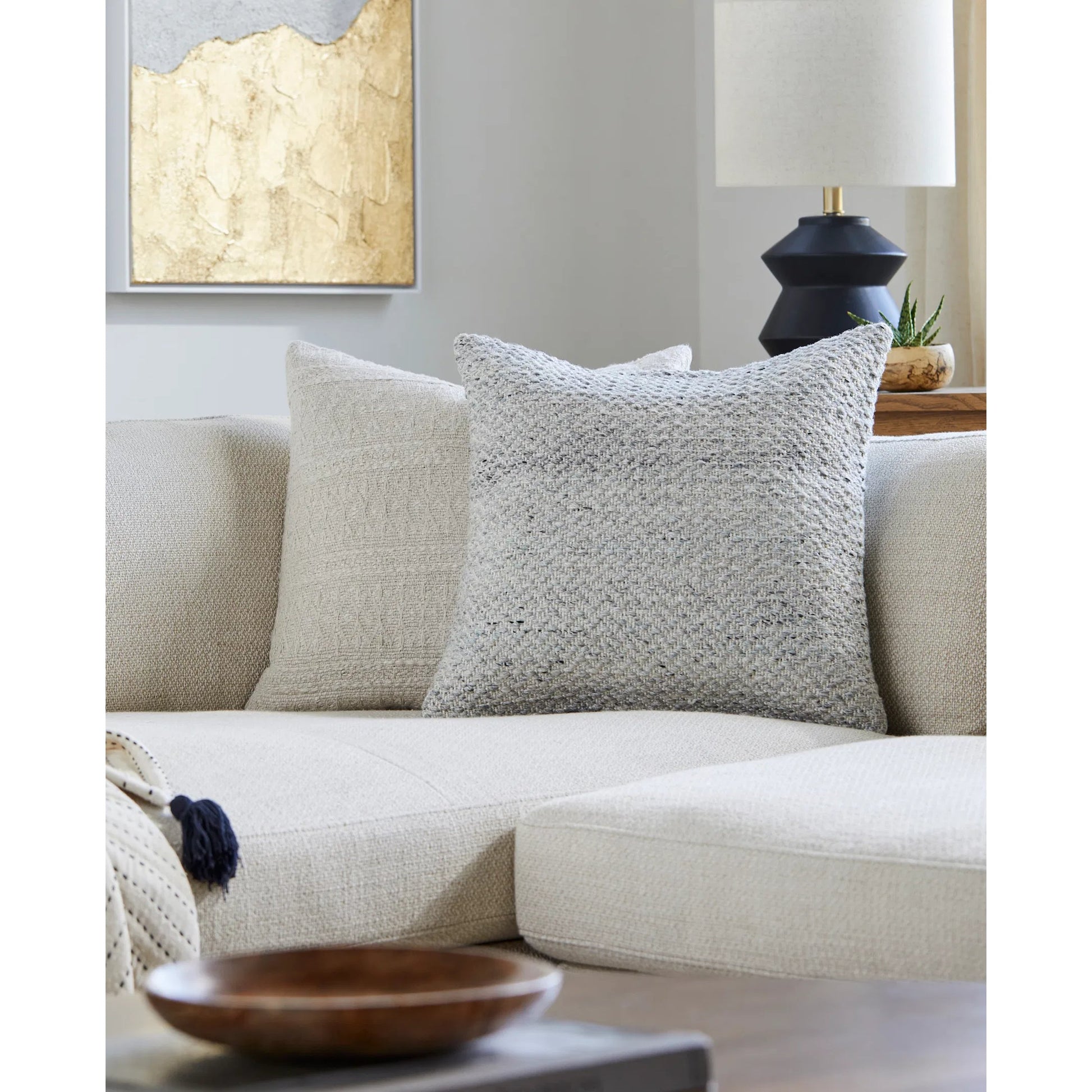 Objective Indoor/Outdoor Pillow by Livabliss in light gray, slate, cream. Made from front: 100% recycled pet yarn, back: 100% polyester in a modern style.