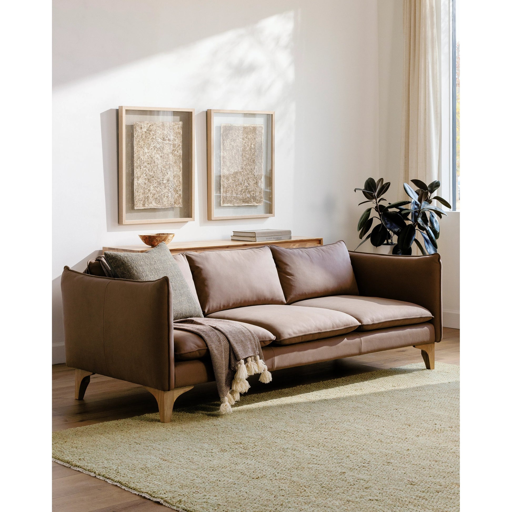 Simone Sofa by Surya in brown and lacquered. Made from upholstery: leather, base: rubber wood, fill: 70% polyurethane foam, 30% mixed feather in a modern style.