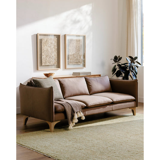 Simone Sofa by Surya in light brown and lacquered. Made from upholstery: leather, base: rubber wood, fill: 70% polyurethane foam, 30% mixed feather in a modern style.