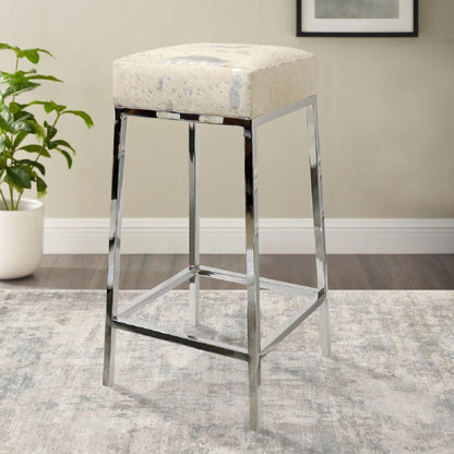 Safari Cowhide Bar Stool by Pasargad Home in silver. Made from steel, cow h in a modern style.