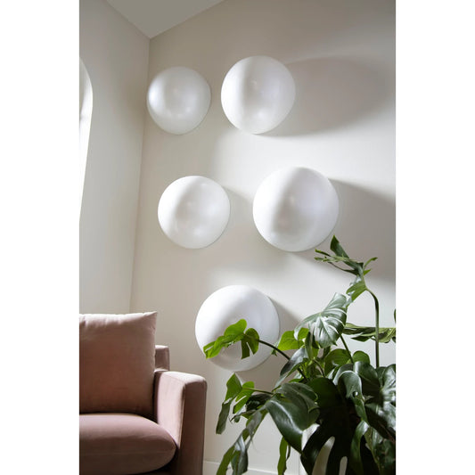 Sphere-In-Half Wall Sculpture by Phillips Collection in pearl white. Made from resin in a modern style.