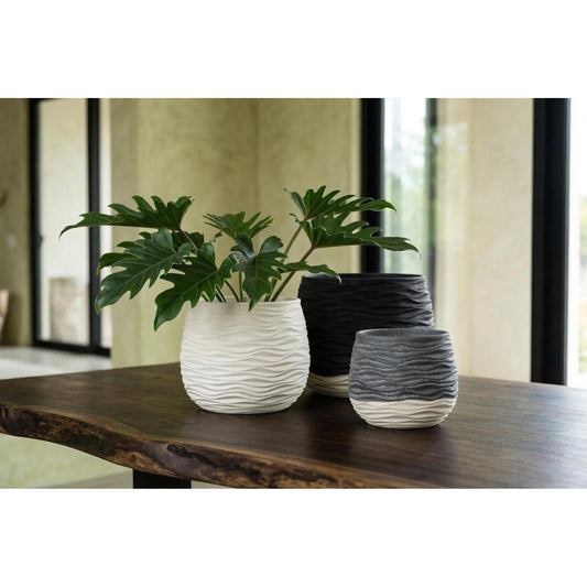Wavy Vase by Phillips Collection. Made from resin in a unique style.