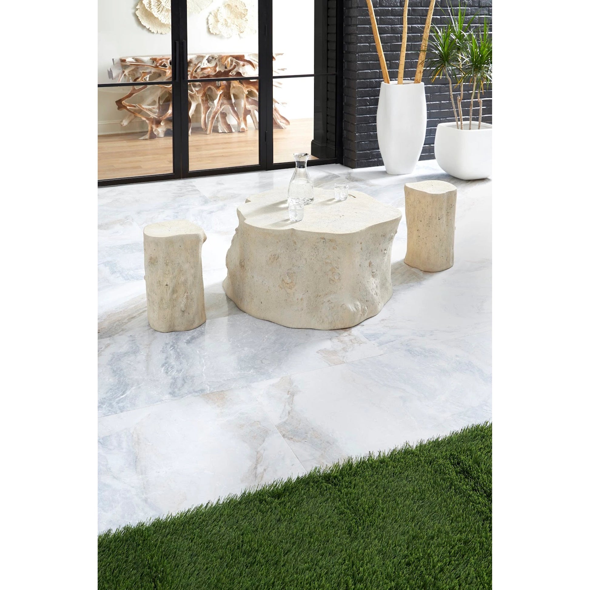 Log Roman Stone Stool by Phillips Collection in off white and roman stone. Made from resin composite in a eclectic & global style.