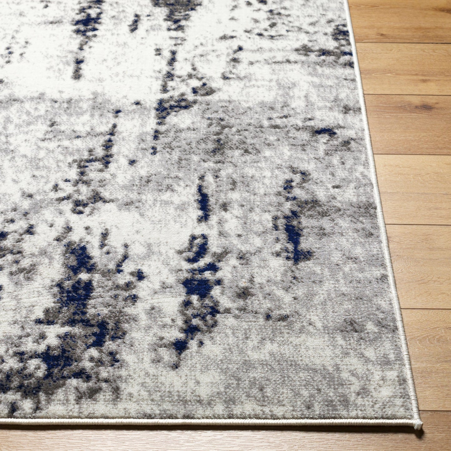004 SI-2045252,SI-2045253,SI-2045254 | Closeup | Pisa Rug - 14634 by Livabliss in light gray, medium gray, charcoal, dark blue. Made from face: 100% polypropylene, warp: 100% polypropylene in a unique style.