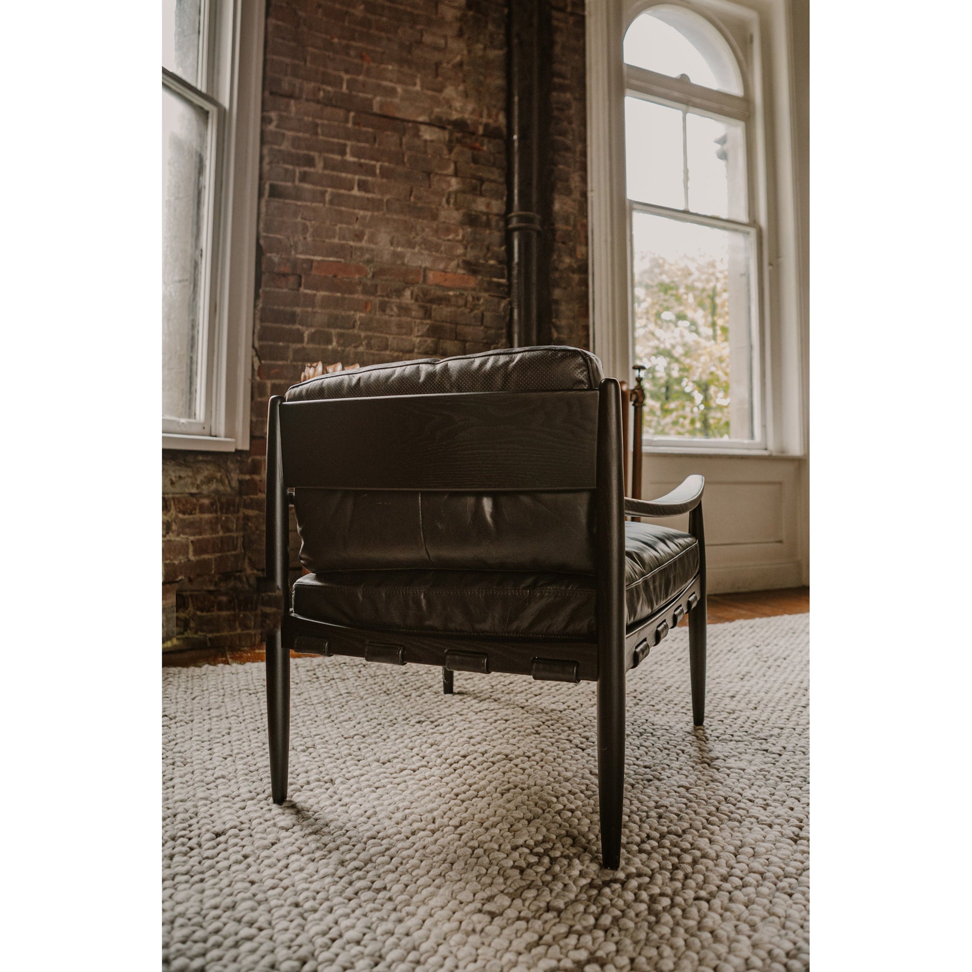 Turner Chair by Moe's Home Collection in black. Made from ash wood frame, top-grain buffalo leather, foam cushion with a feather wrap in a modern style.