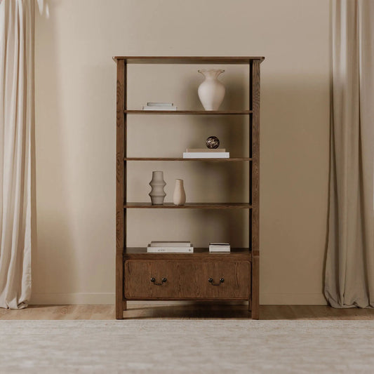 Caroline Bookcase by Moe's Home Collection in warm brown. Made from solid oak frame, oak veneer over mdf side panel, drawer in a unique style.