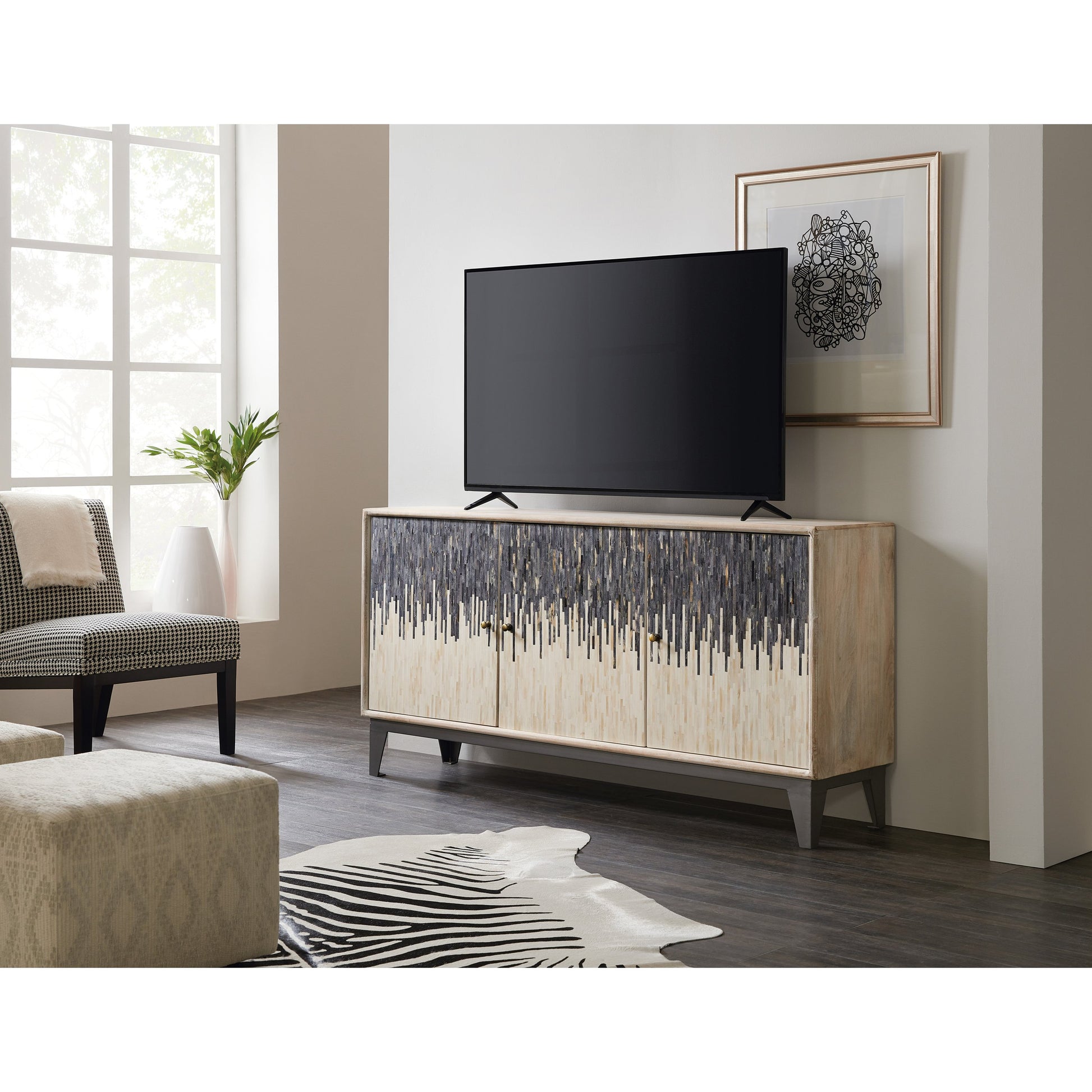 Three Door Entertainment Console by Hooker Furniture in rustic light mango. Made from mango wood with iron, bone in a transitional style.