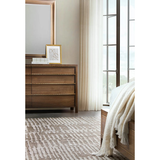 Eleana Eight Drawer Dresser by Hooker Furniture in light caramel, quartered walnut veneers, sunlit bronze metal. Made from walnut veneers in a traditional style.