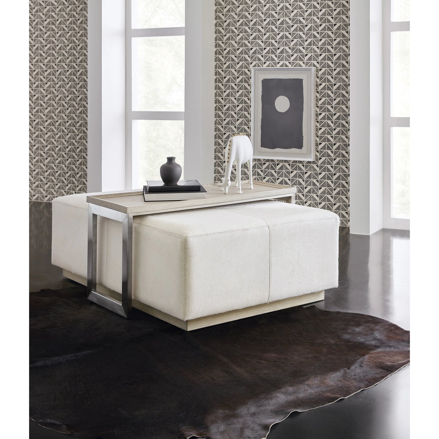 004 SI-2133597 | Lifestyle | Melange Bridged Cocktail Table by Hooker Furniture in light wood. Made from hair on hide leather with metal, veneer in a modern style.