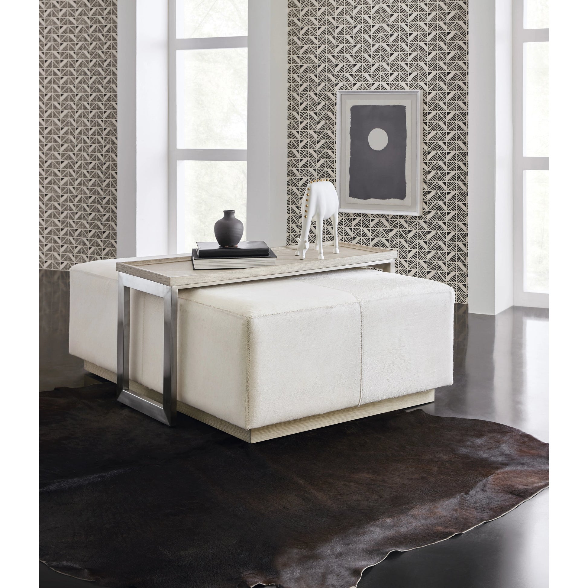 Melange Bridged Cocktail Table by Hooker Furniture in light wood. Made from hair on hide leather with metal, veneer in a modern style.