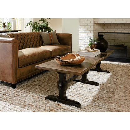 Americana Trestle Rectangle Cocktail Table by Hooker Furniture in black and molasses finish. Made from oak veneers with solid-wood edge top in a modern style.