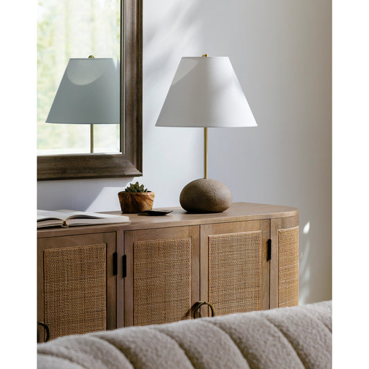 Rhodes Table Lamp by Surya in body: brown, metallic - brass, shade: white, finial: metallic - brass, harp: metallic - brass, cord: translucent and plated. Made from body: cement, metal, shade (outside): cotton, finial: metal in