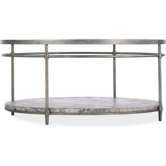 Round Cocktail Table by Hooker Furniture in champagne. Made from concrete with metal tubing, metal sheet, glass in a transitional style.