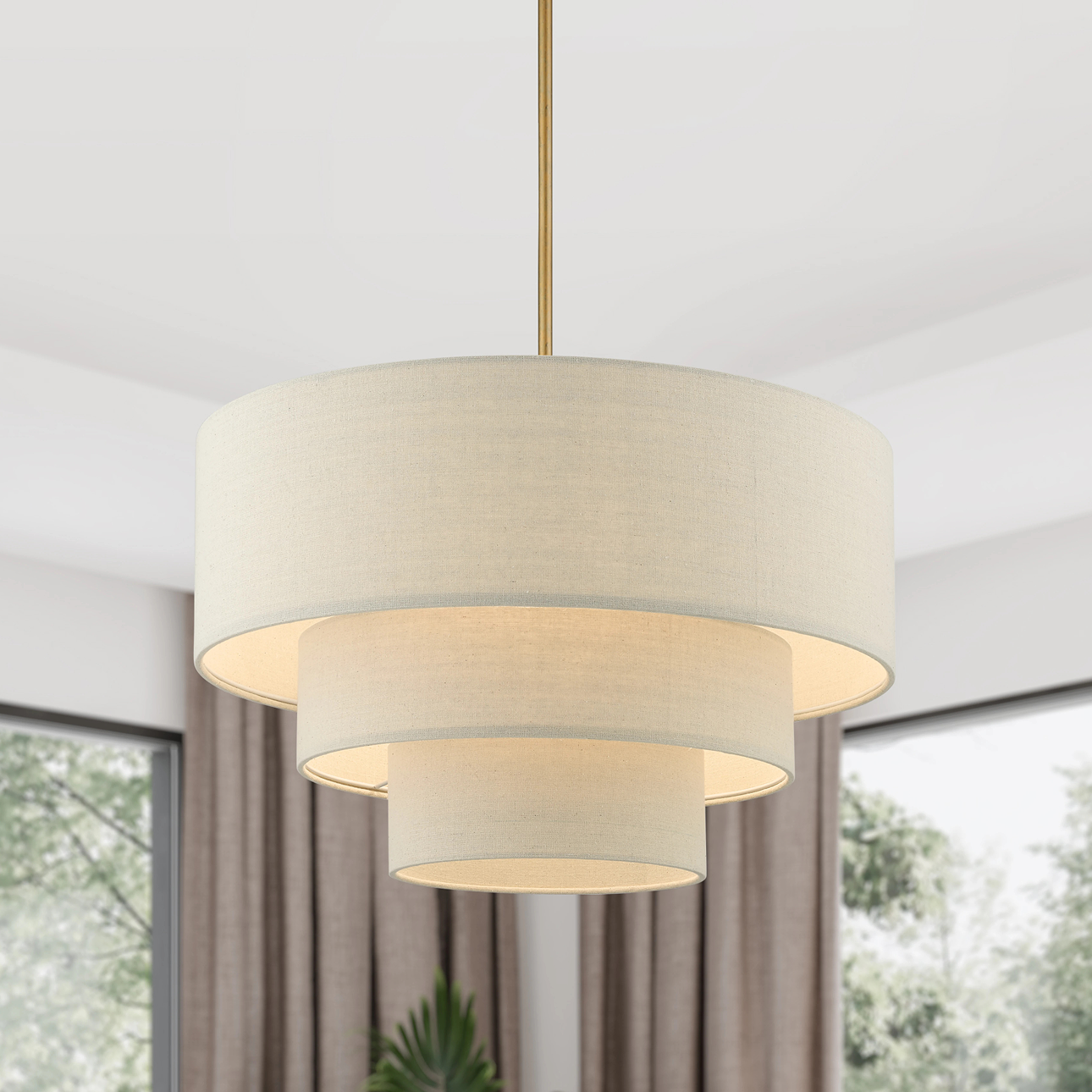 Contemporary tiered drum chandelier with a soft linen shade and warm glow, perfect for modern interiors—shop lighting now on sale.