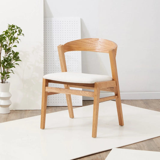 Abigayle and Boucle Dining Chair by Safavieh in ivory, natural. Made from oak, plywood, boucle (100% polyester) in a modern style.