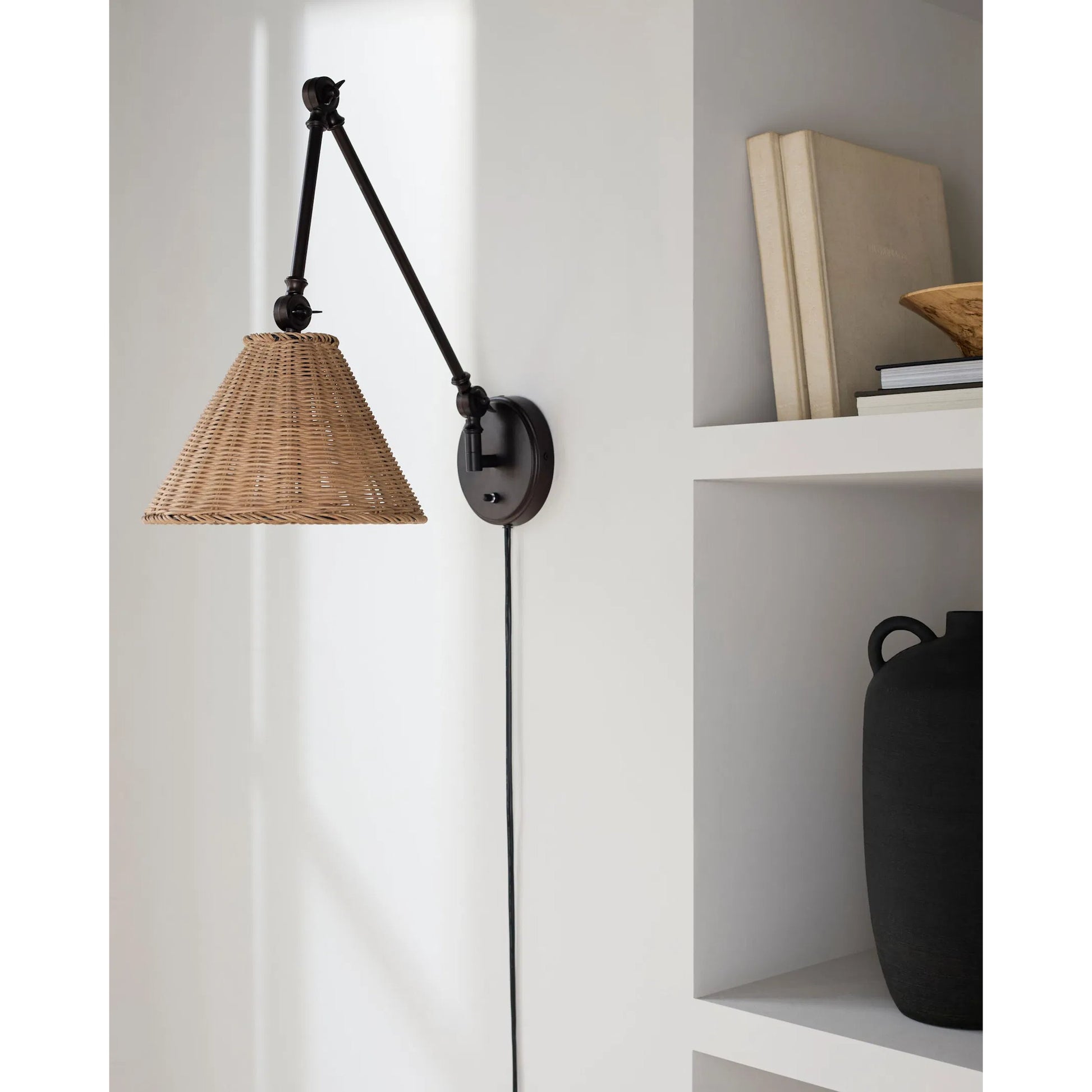 Semilla Wall Sconce Swing Arm by Livabliss in fixture: black; shade: brown; cord: white and paintedpaintedmetallic. Made from iron, rattan in a rustic style.