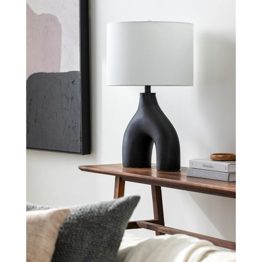 Solara Accent Lamp by Livabliss in body: black, shade: white, finial: black, harp: metallic - brass, cord: translucent and glazed. Made from body: ceramic, metal, shade (outside): cotton, finial: metal in a modern style.