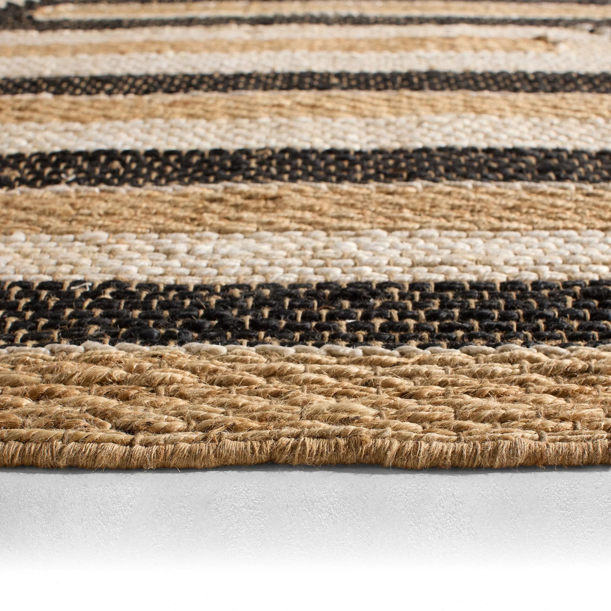 Song Of The Sahara SOS02 Rug by Jaipur Living in tan, beige, black. Made from 100% jute in a unique style.