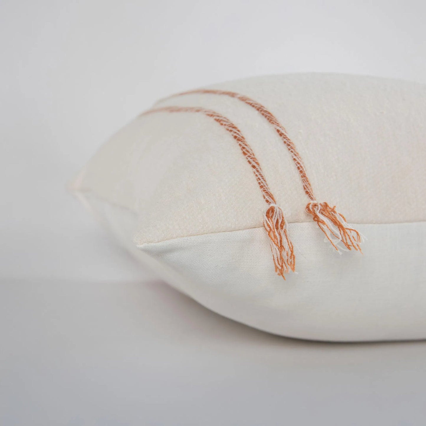 004 SI-2438632 | Closeup | Albany Pillow by HedgeApple Essentials in ivory, terra cotta. Made from cotton boucle in a transitional style.