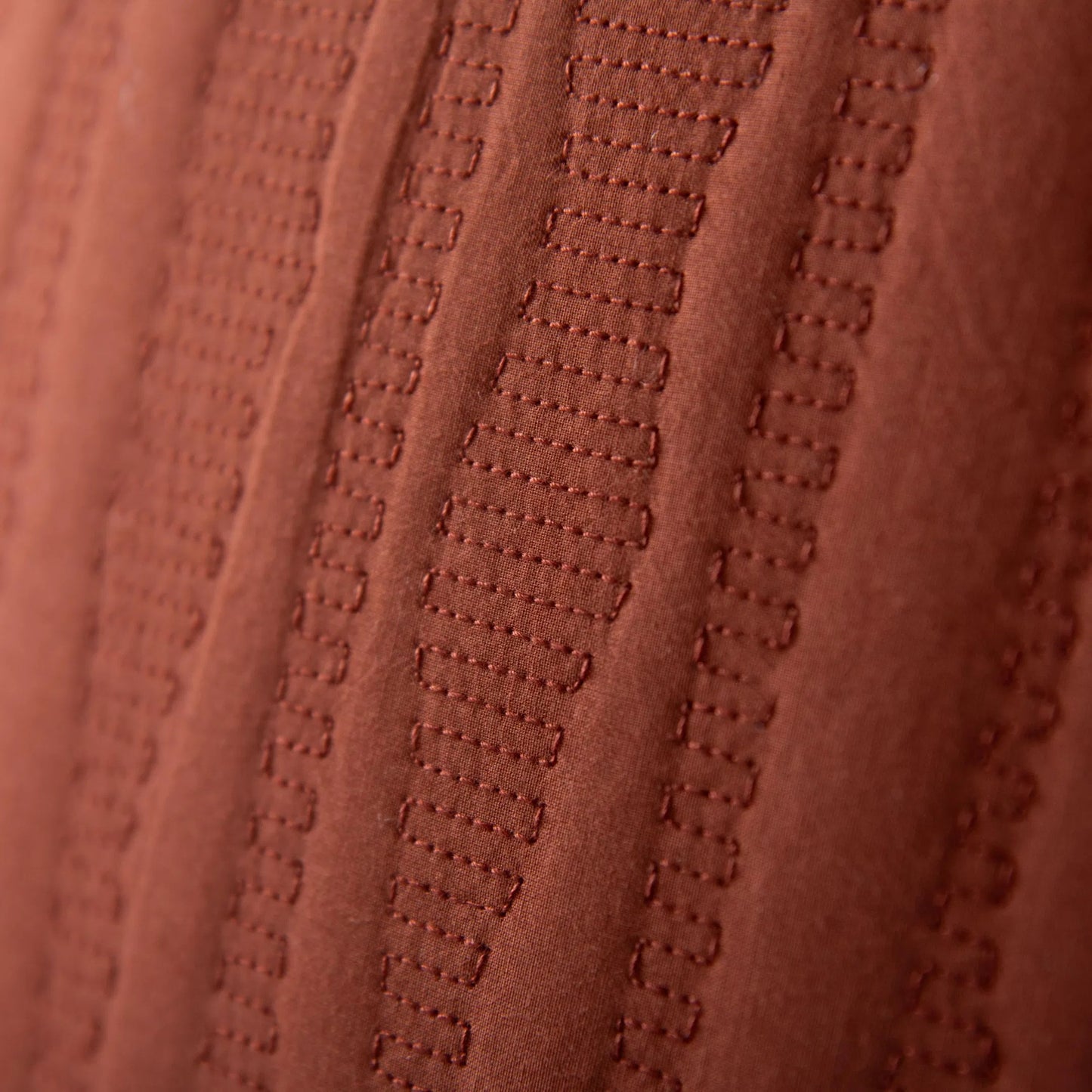 002 SI-2296011,SI-2438529 | Closeup | Kanabec Pillow by HedgeApple Essentials in rust. Made from polyester, cotton voile in a eclectic & global style.