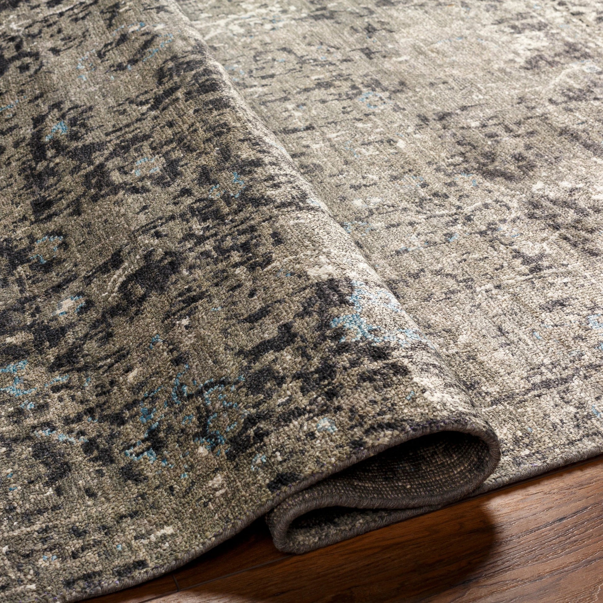 Theodora Rug - 30279 by Surya in charcoal, ice blue, gray, medium gray, light gray, black. Made from 100% viscose in a unique style.