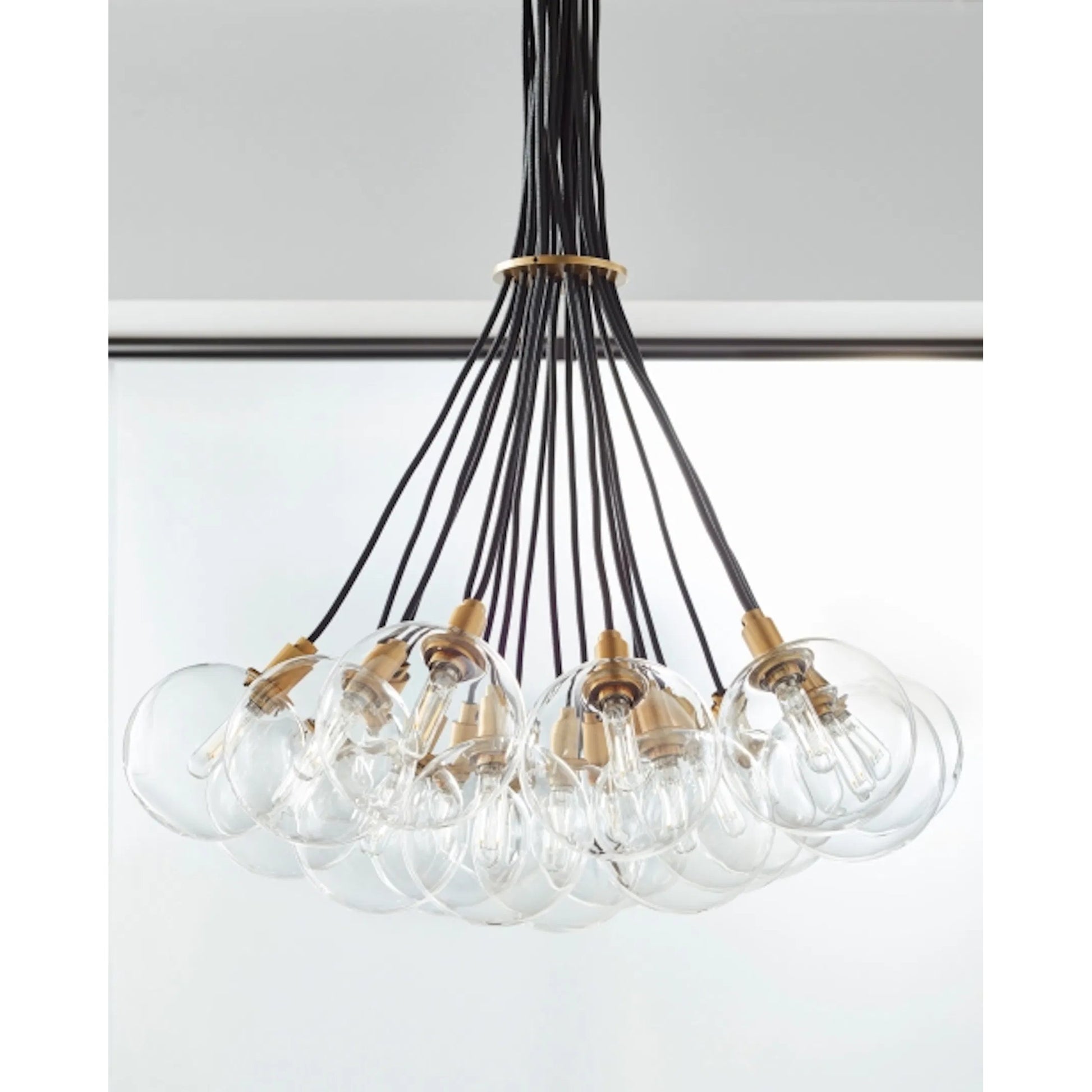 Gambit Multi-Port Chandelier by Tech Lighting in aged brass. Made from glass in a modern style.