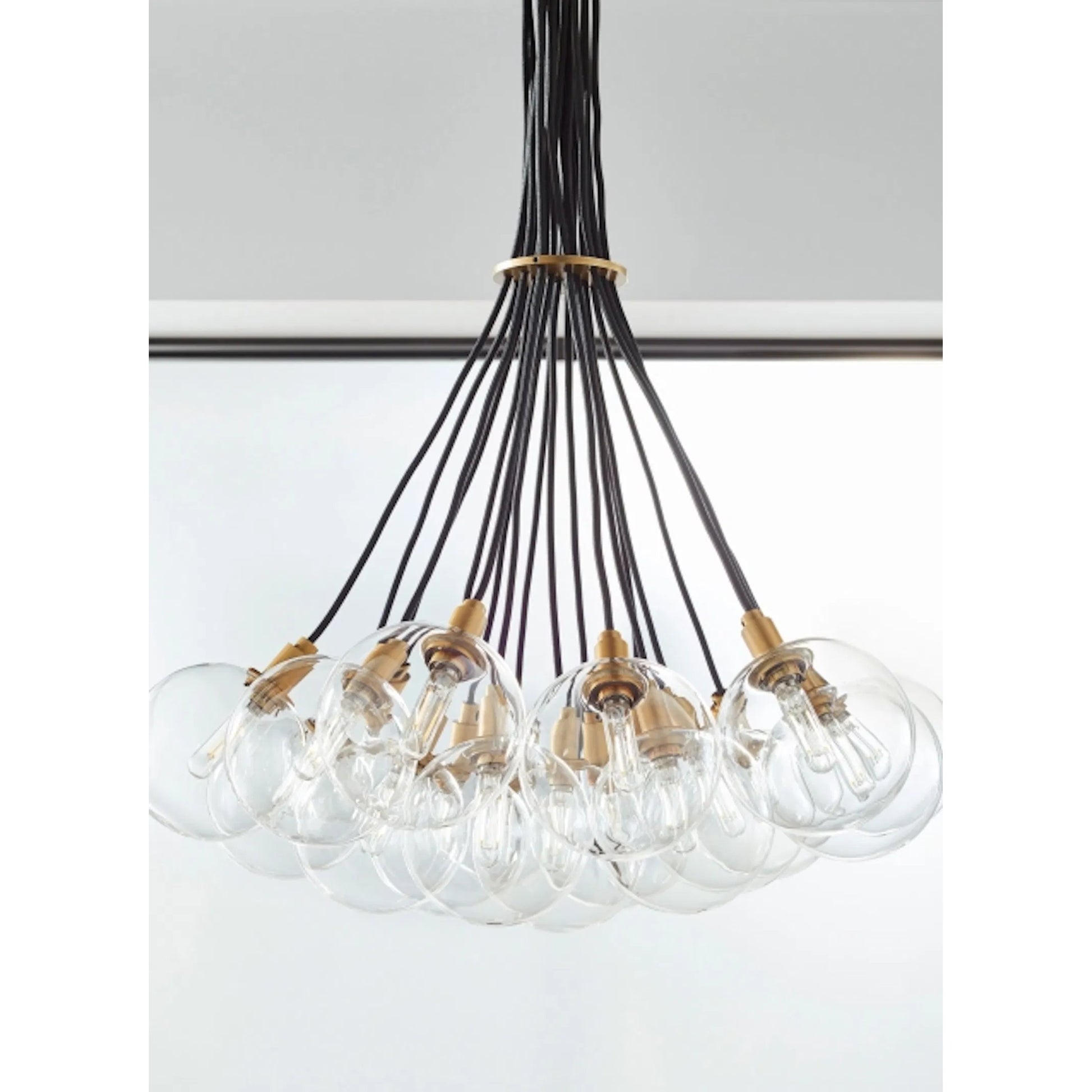 Gambit Multi-Port Chandelier by Tech Lighting in aged brass. Made from glass in a modern style.