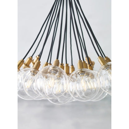Gambit Multi-Port Chandelier by Tech Lighting in aged brass. Made from glass in a modern style.