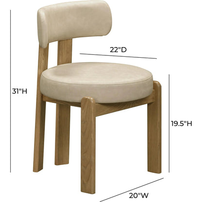 Odessa Vegan Leather Dining Chair by TOV Furniture. Made from faux leather, wood in a transitional style.