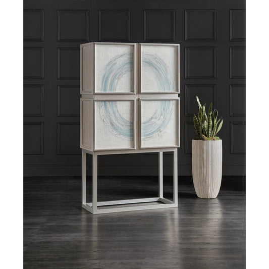 Melange Kandin Bar Cabinet by Hooker Furniture in light gray. Made from oak veneers, linen, metal, glass, puck light in a modern style.