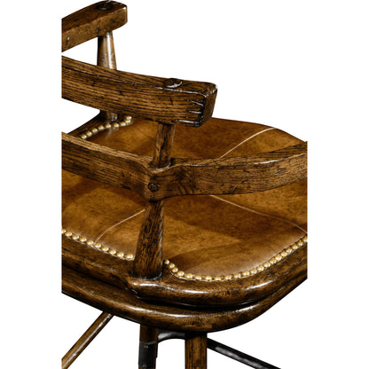 Casual Accents Tudor Oak Studded Leather Bar Stool by Jonathan Charles in brown and dark brown tudor oak. Made from oak in a rustic style.