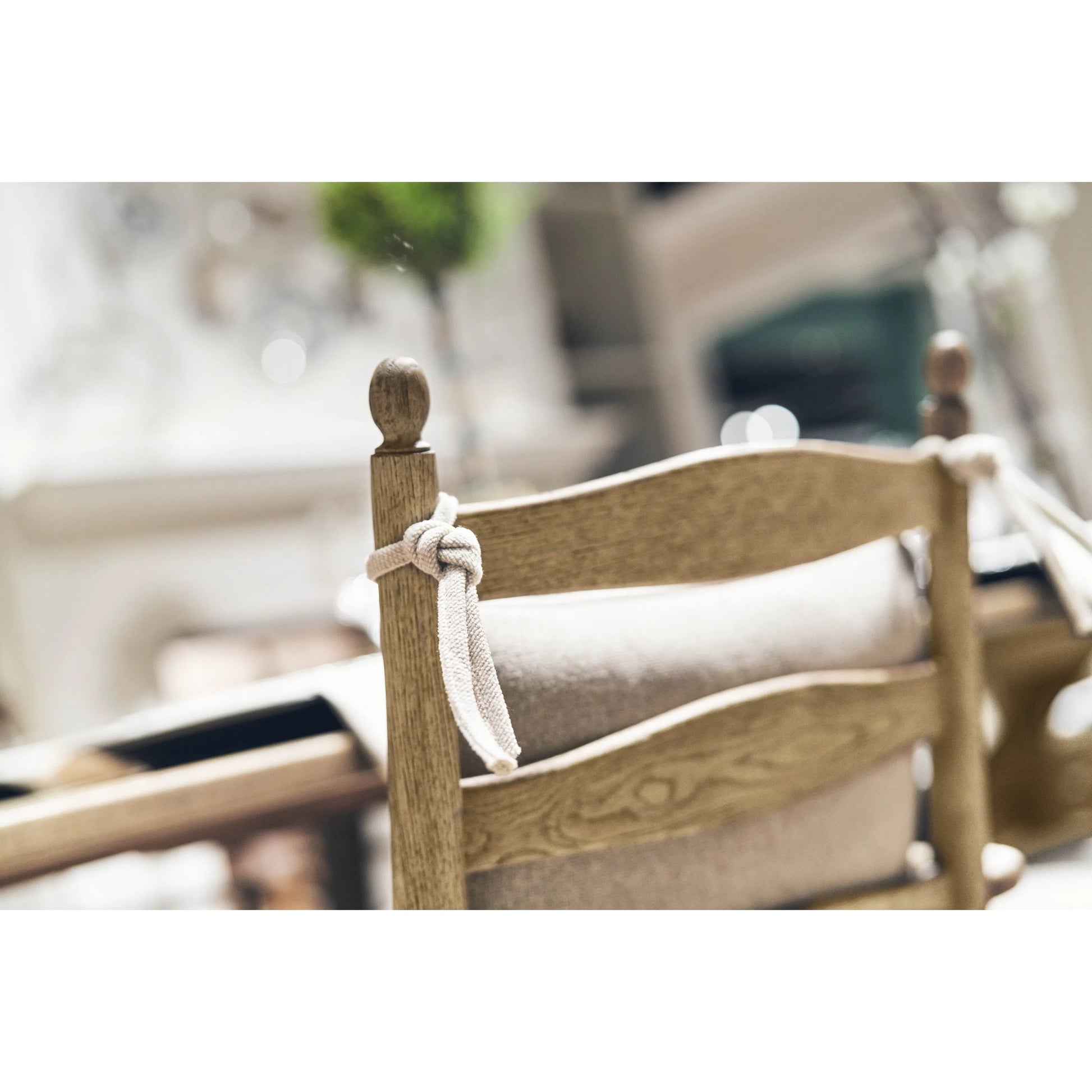 Timeless Doppler Ladderback Arm Chair by Jonathan Charles in stripped brown chestnut. Made from oak, fiber rush, foam, fabric in a coastal style.