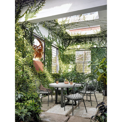 Cyrus Outdoor Round Dining Table by Four Hands. Made from lavastone composite, iron in a modern style.