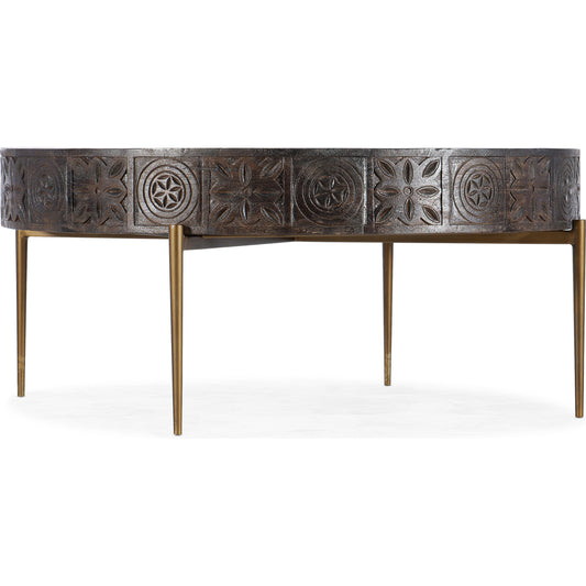 Commerce & Market Carved Round Cocktail Table by Hooker Furniture in dark wood. Made from mango wood, iron in a eclectic & global style.