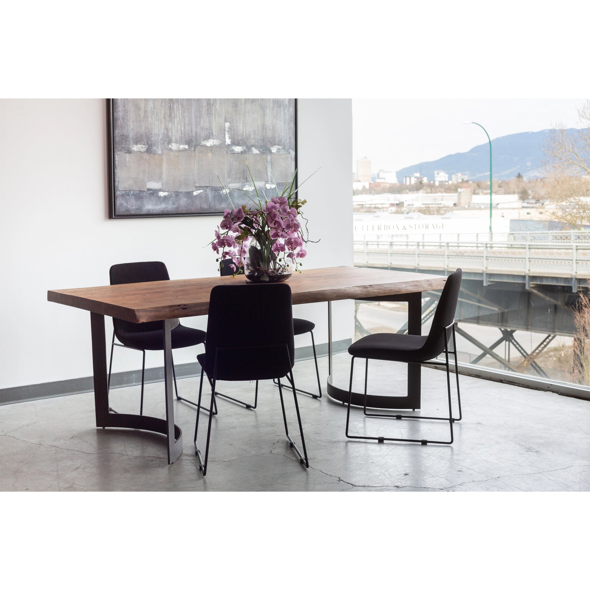 Bent Dining Table by Moe's Home Collection in brown. Made from solid acacia, iron base in a modern style.