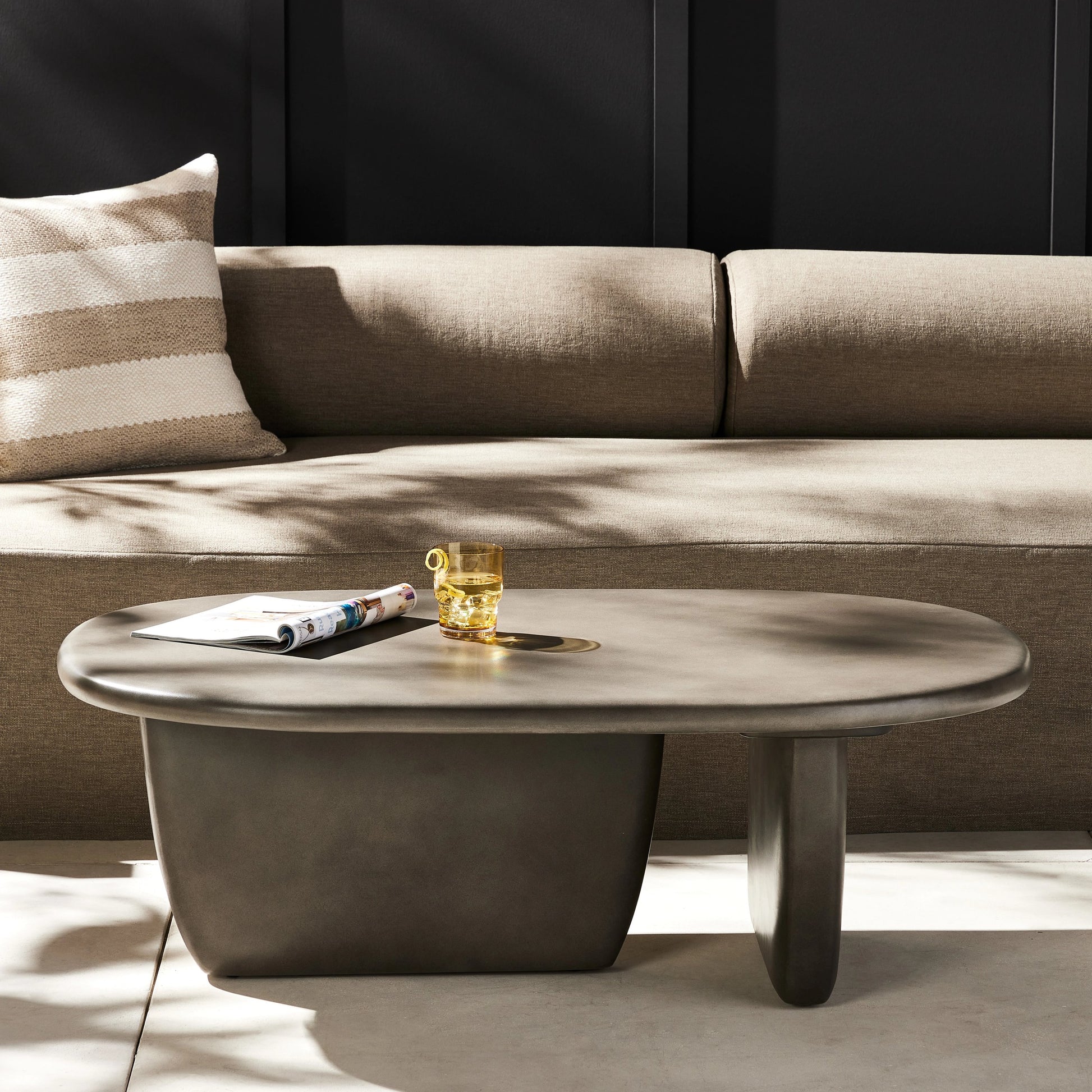 Naya Outdoor Coffee Table by Four Hands in dark grey and dark gray. Made from concrete in a modern style.