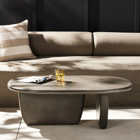 Naya Outdoor Coffee Table by Four Hands in dark grey and dark gray. Made from concrete in a modern style.